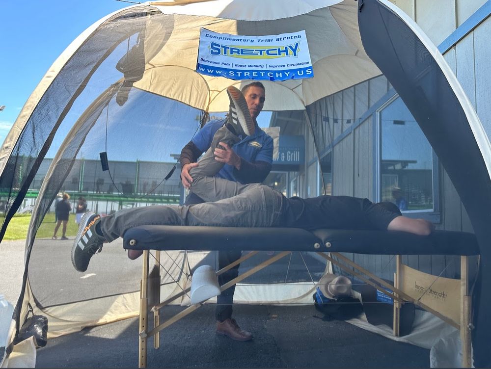 Brandon performing a hamstring stretch on a client
